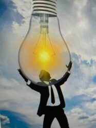 Man holding a lightbulb for blog post We’re making the Bible easier to understand so people can know God!